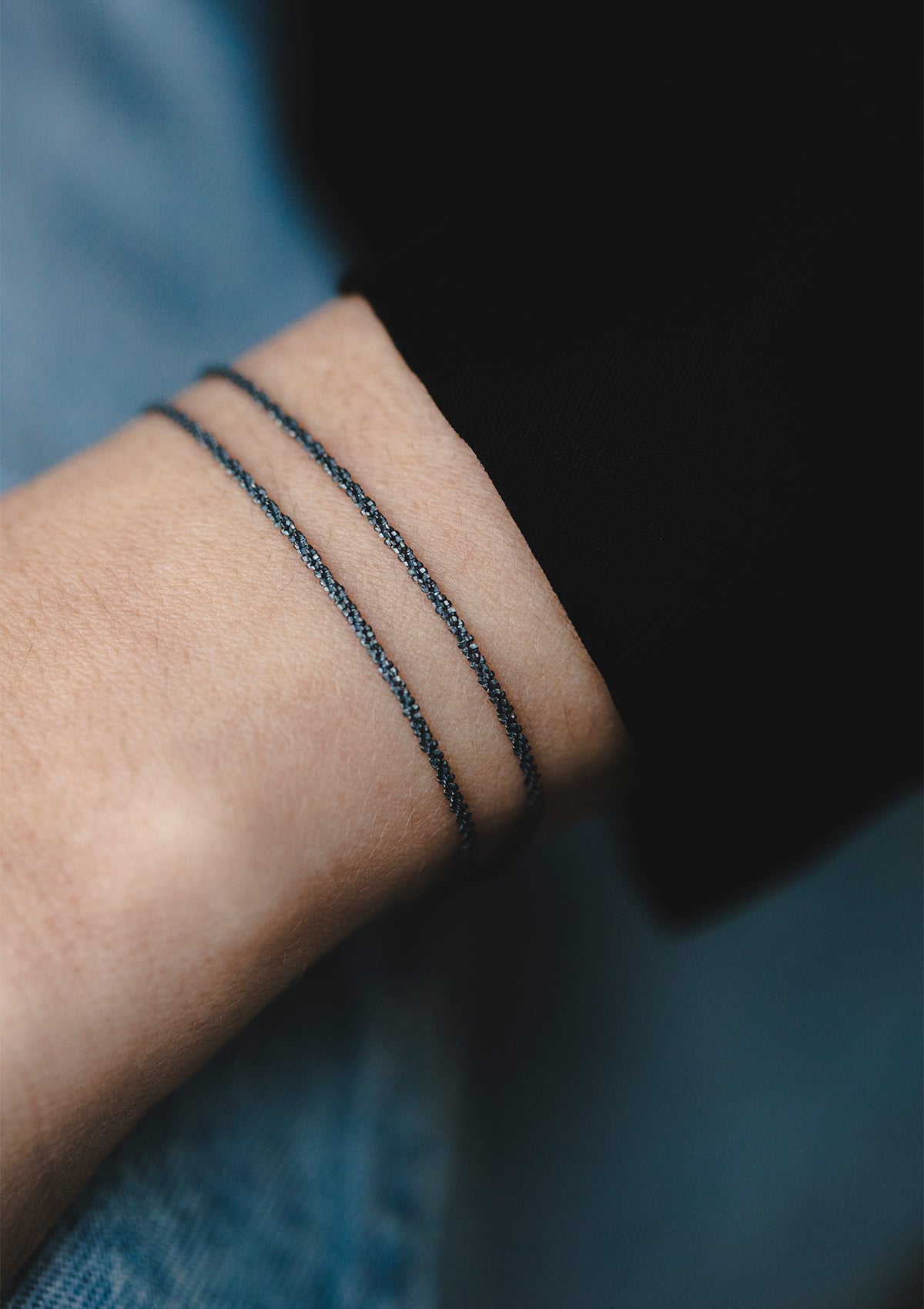 Black double-chain sterling silver bracelet worn on wrist – minimalist style