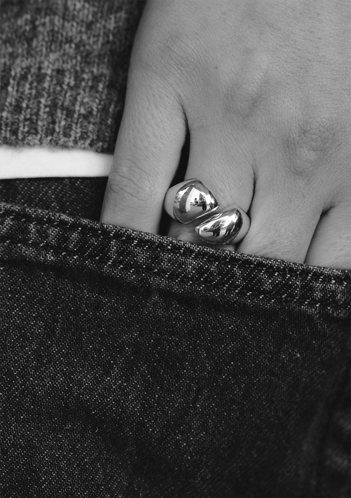 Adjustable silver ring styled casually, sleek sculptural jewelry for expressive everyday wear