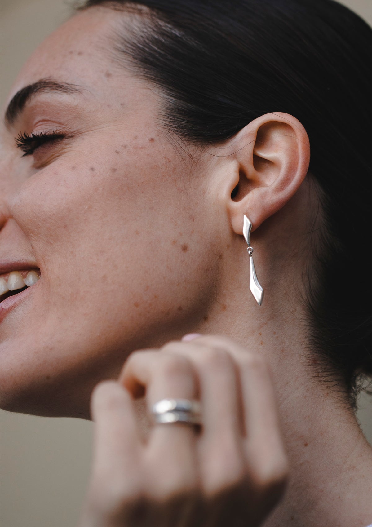 Elegant silver drop earrings worn close to neck, designer jewelry for everyday or occasion wear