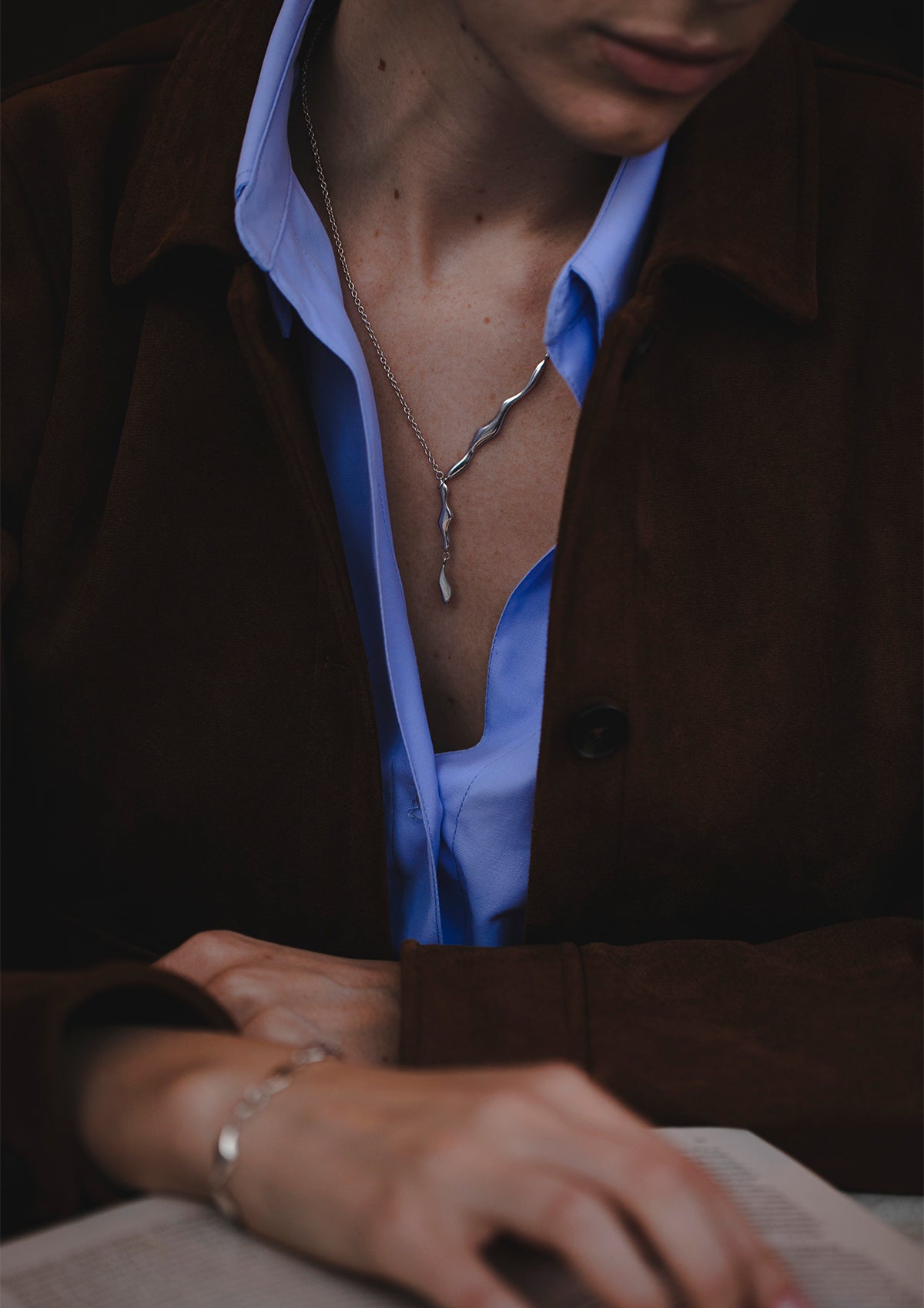 Contemporary sterling silver lariat necklace with fluid design, elegant asymmetric piece for layering