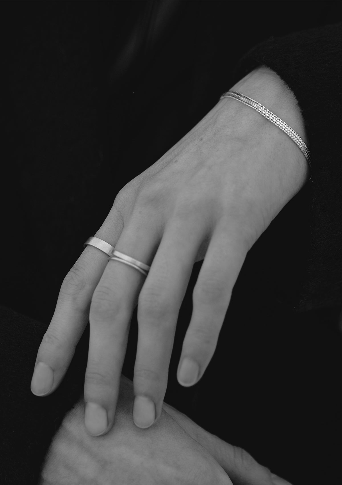 Sterling silver chain bracelet shown with monochrome outfit, sleek styling for minimalist jewelry lovers