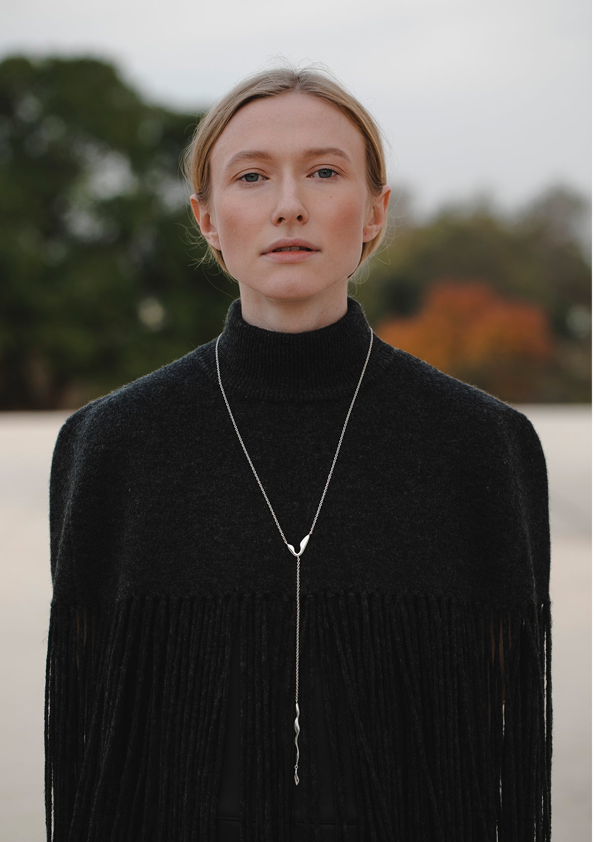 Signature long silver necklace with dangling pendants, bold modern jewelry styled as sautoir