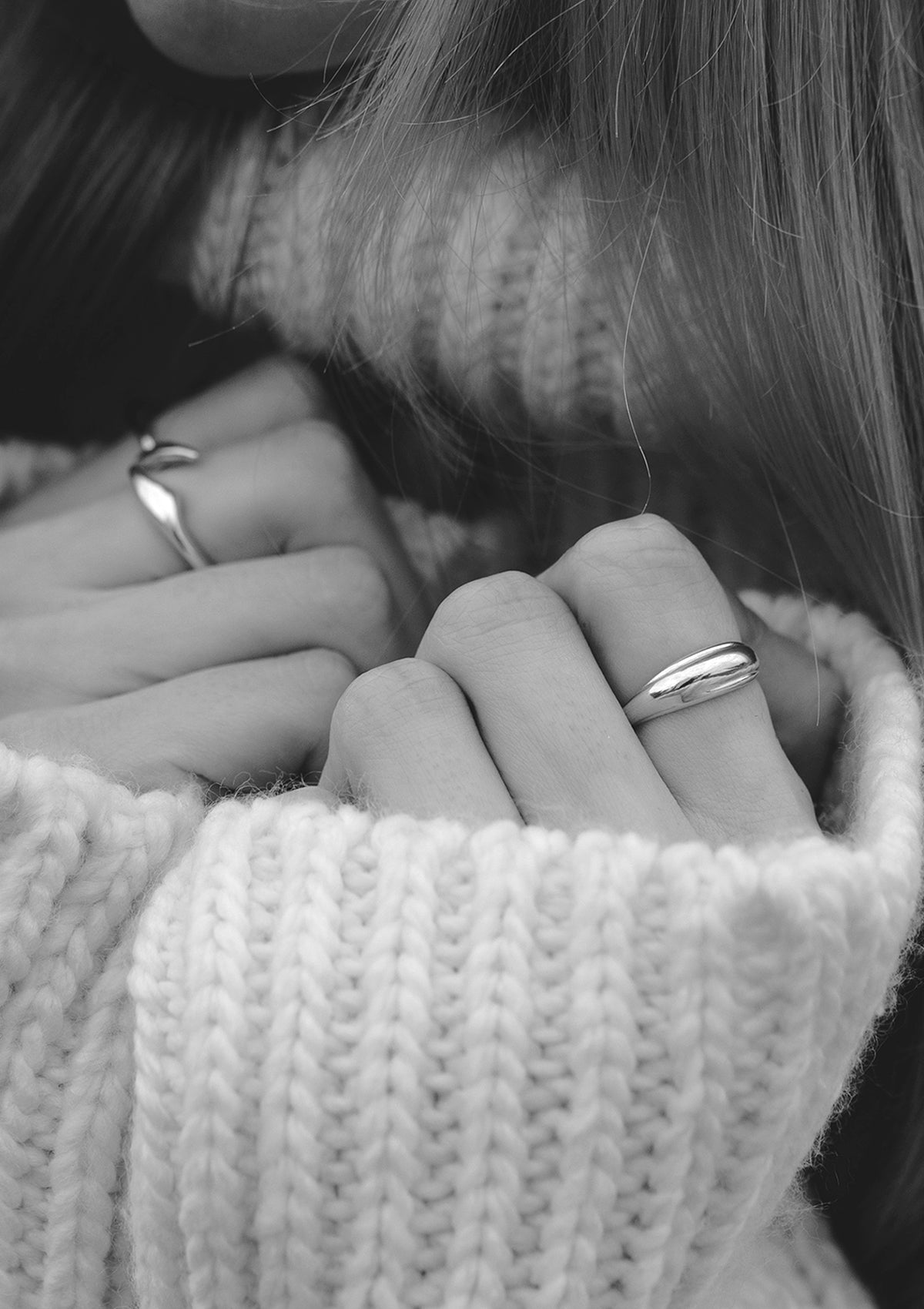 Reflective sterling silver ring worn on finger, modern handcrafted jewelry with organic dome