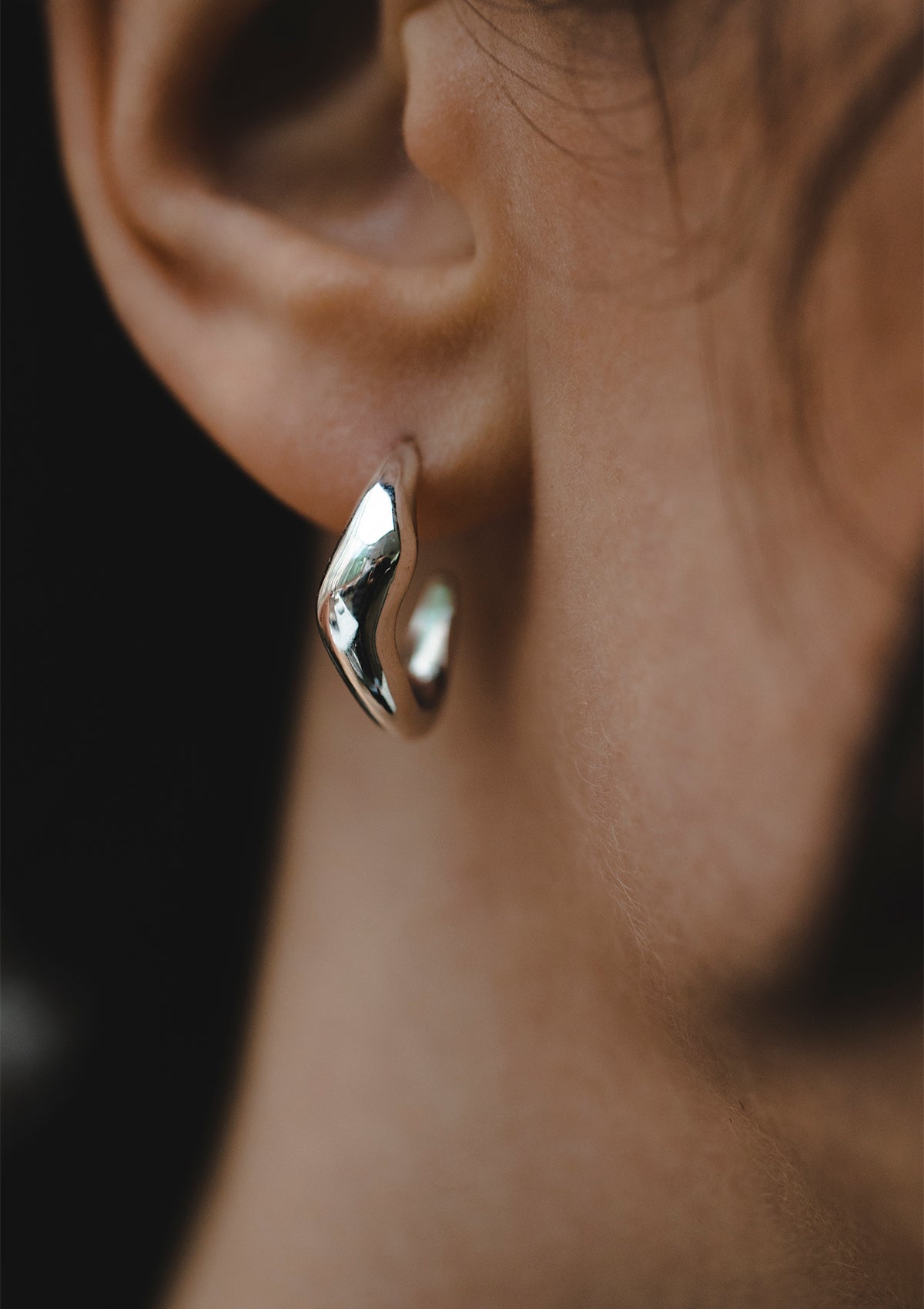Sterling silver hoop earrings with soft curved silhouette, handcrafted everyday studs