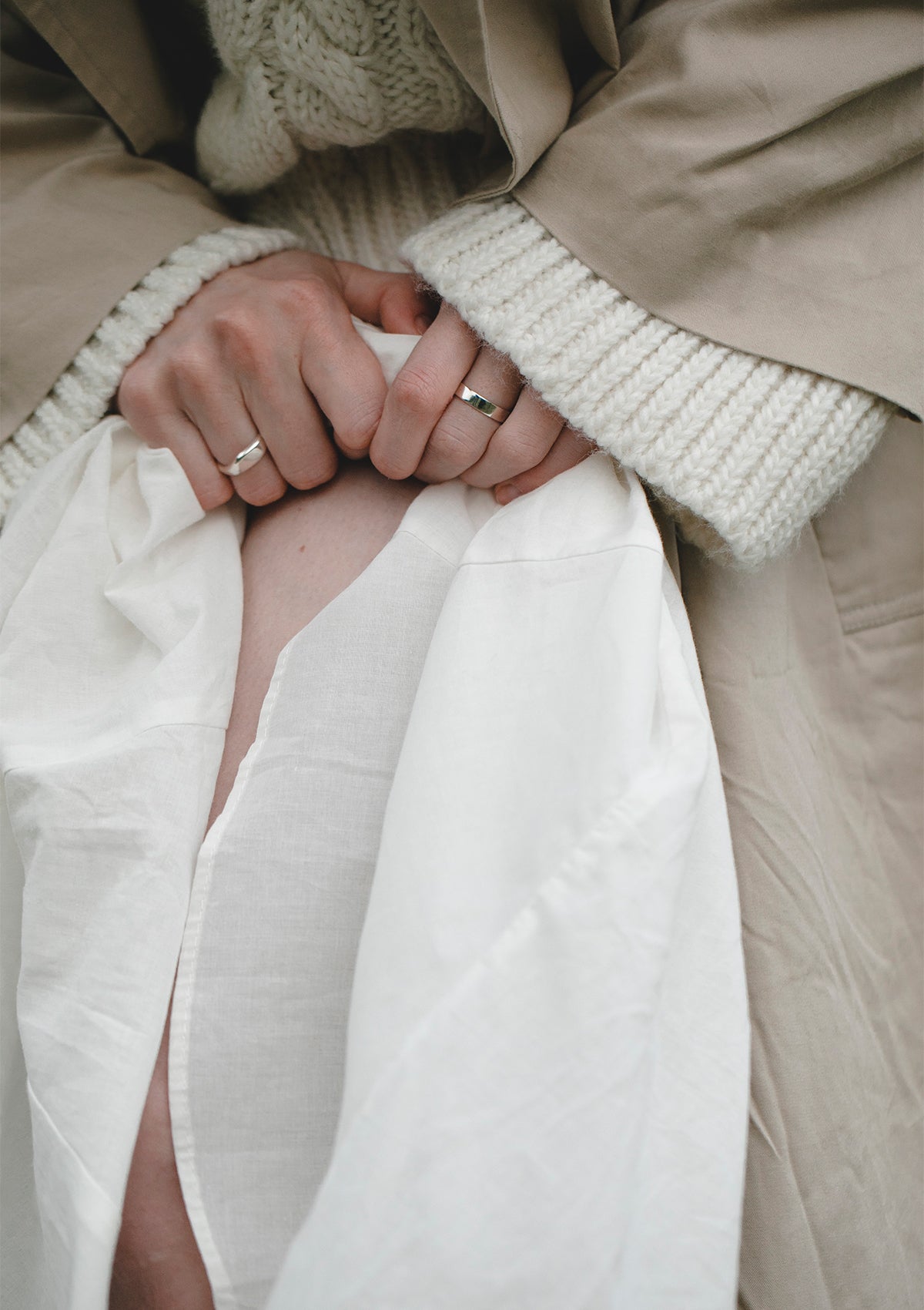 Polished silver band ring in medium 4 mm width, styled casually with natural layers for a minimalist look