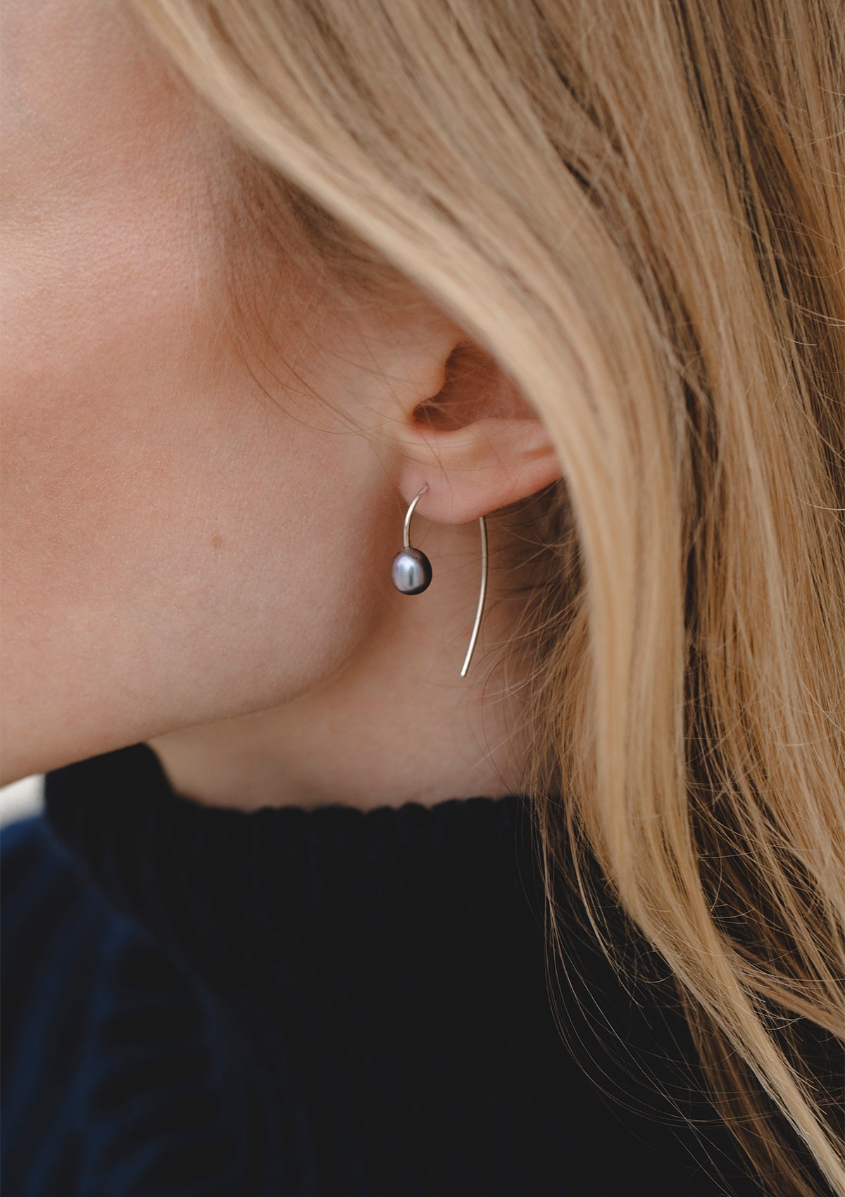 elegant black pearl earrings with purple shimmer – sterling silver hoops worn on ear