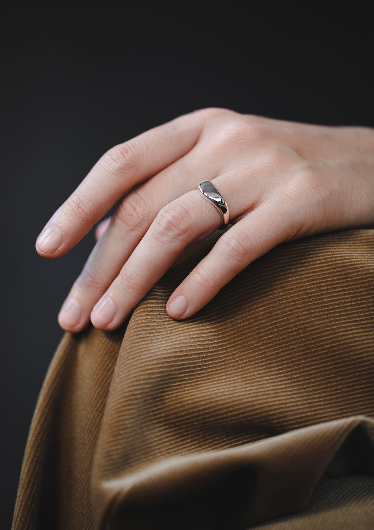 Handcrafted sterling silver ring with soft sculptural wave, polished designer jewelry