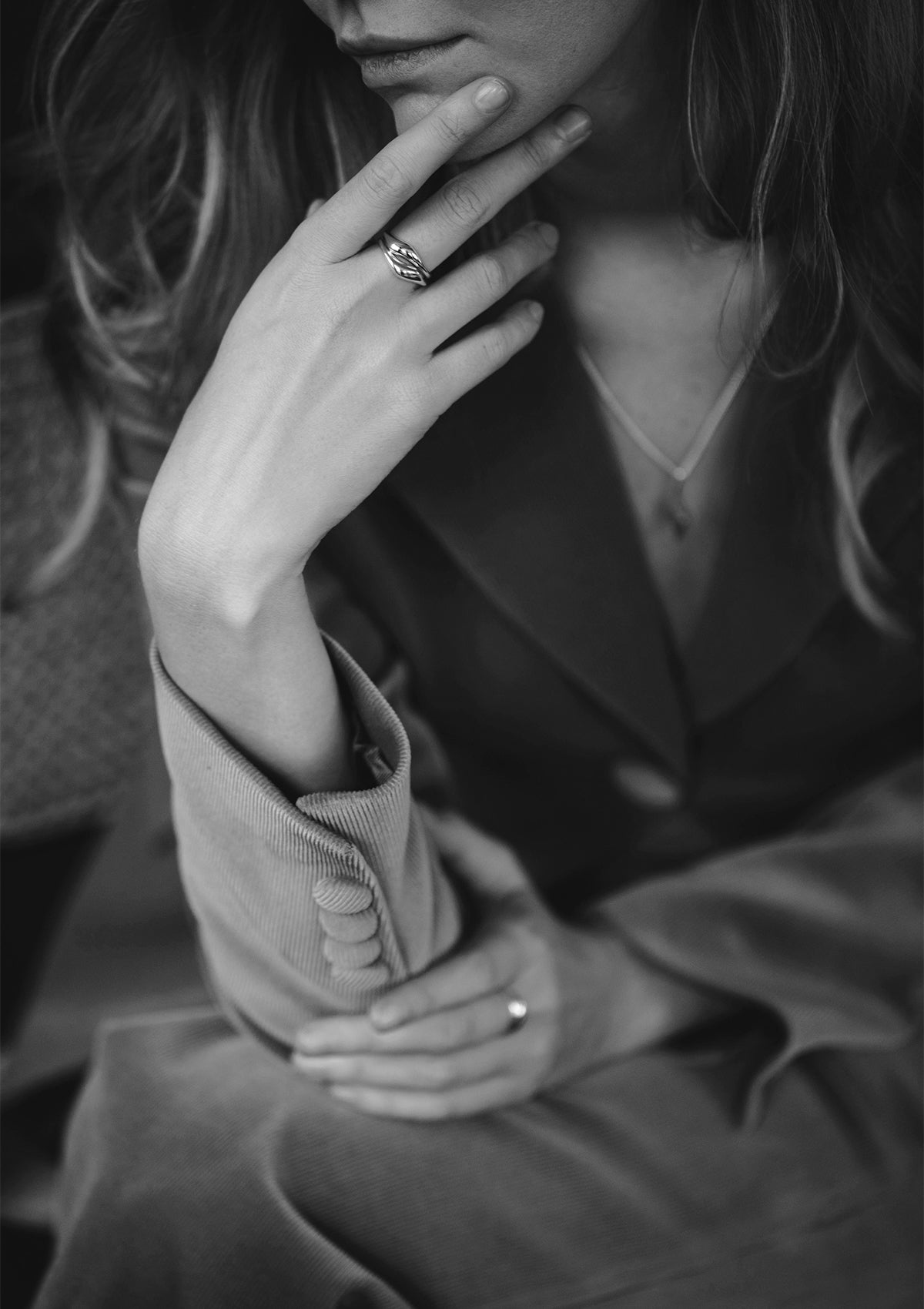 Wavy minimalist sterling silver ring in artistic black and white moody lighting