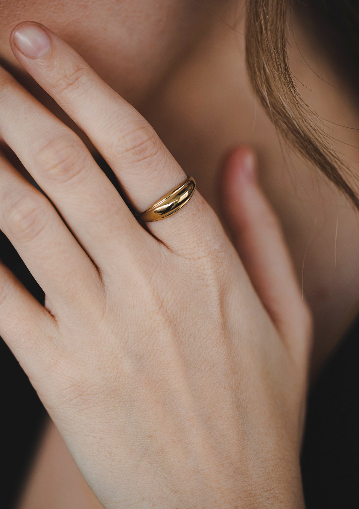 Classic dome ring in solid gold on finger, minimalist women's gold jewelry