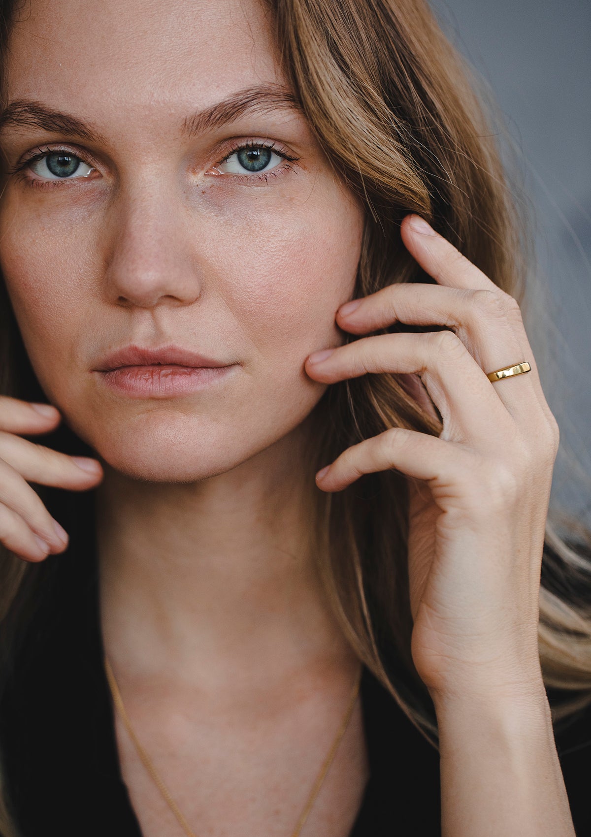 Classic gold band worn by model, versatile for everyday or wedding use