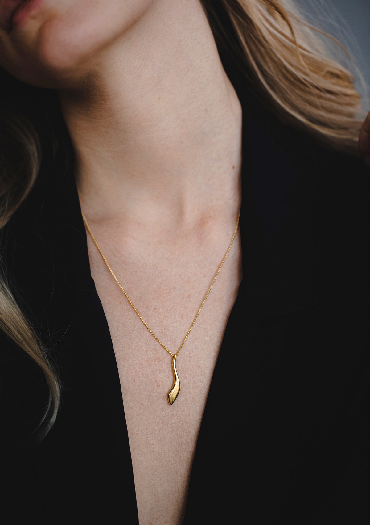 Minimalist gold necklace with soft-edge pendant, delicate everyday piece in 14K gold