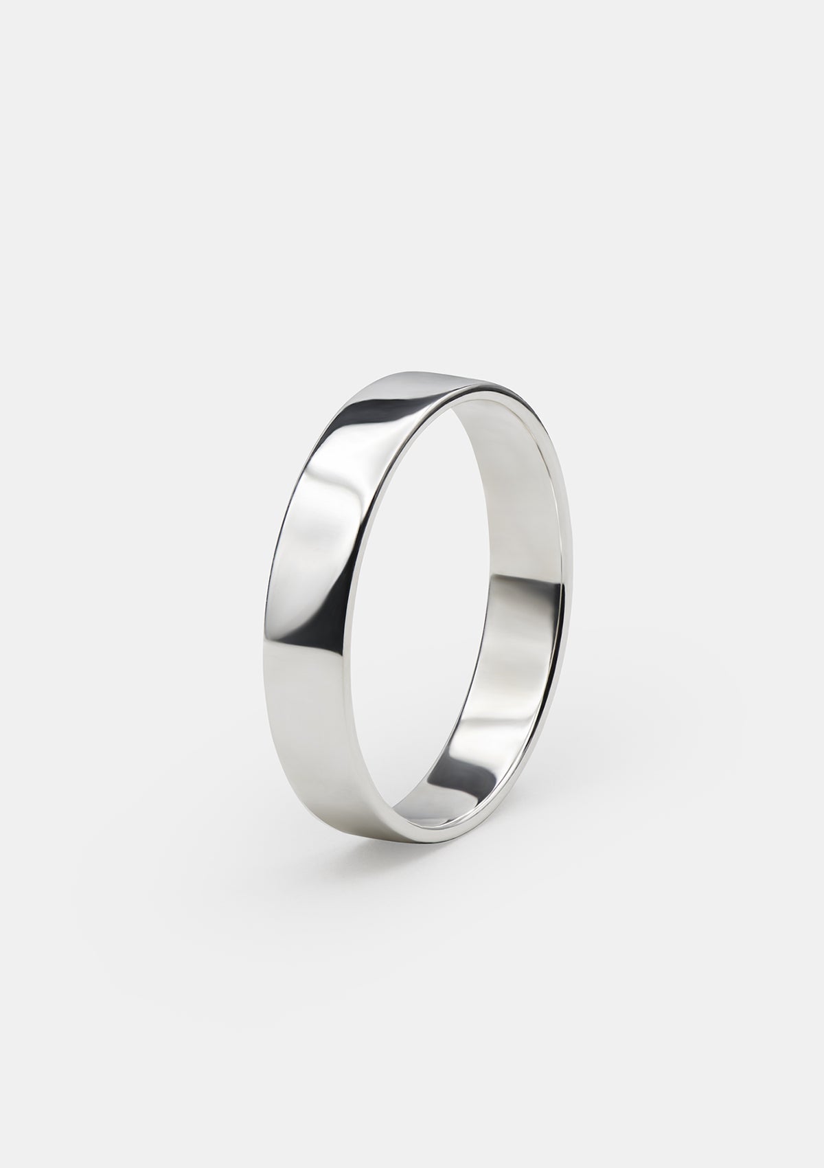 Handmade 925 silver ring seen from side, clean geometry and shiny polished finish emphasized in soft light
