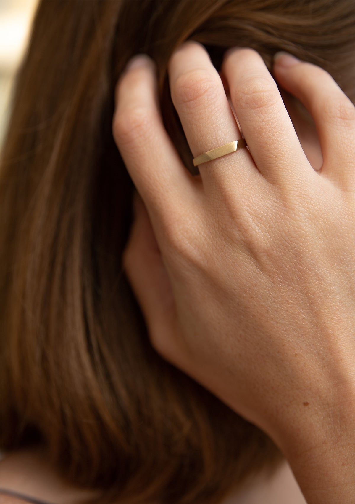 Unusual 14K gold ring with dynamic faceted band, shown in soft matte shine for subtle elegance
