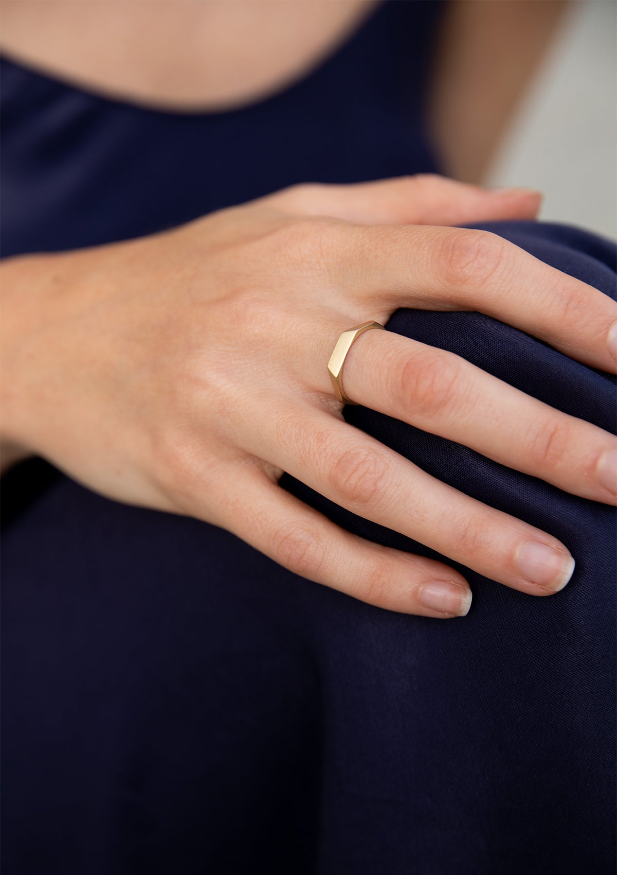 Angled ring in 14K gold with bold geometry, alternative wedding ring styled on finger in profile