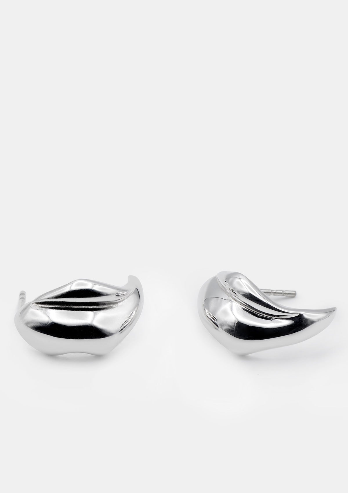 Sculptural sterling silver statement earrings with bold shape, medium minimalist design photographed flat