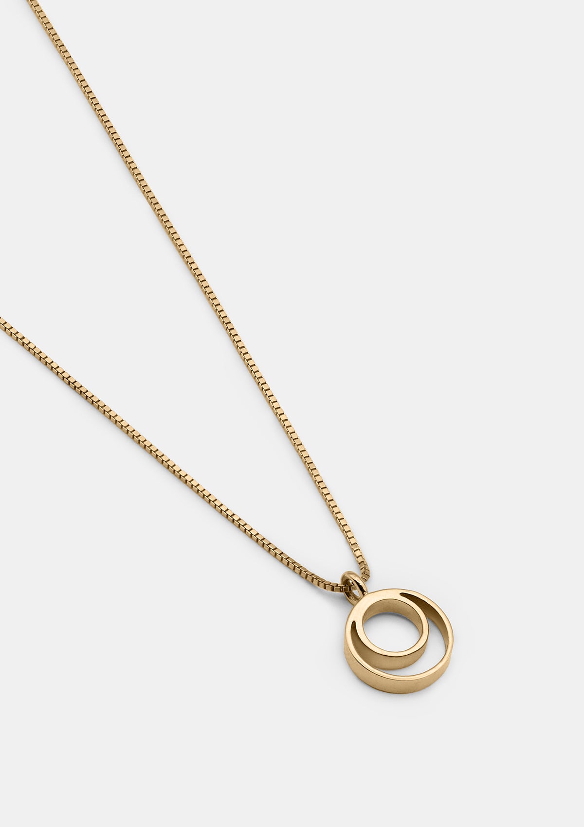 Minimalist 14K gold necklace with interlocking double circles, elegant geometric pendant on fine Venetian chain — photographed flat
