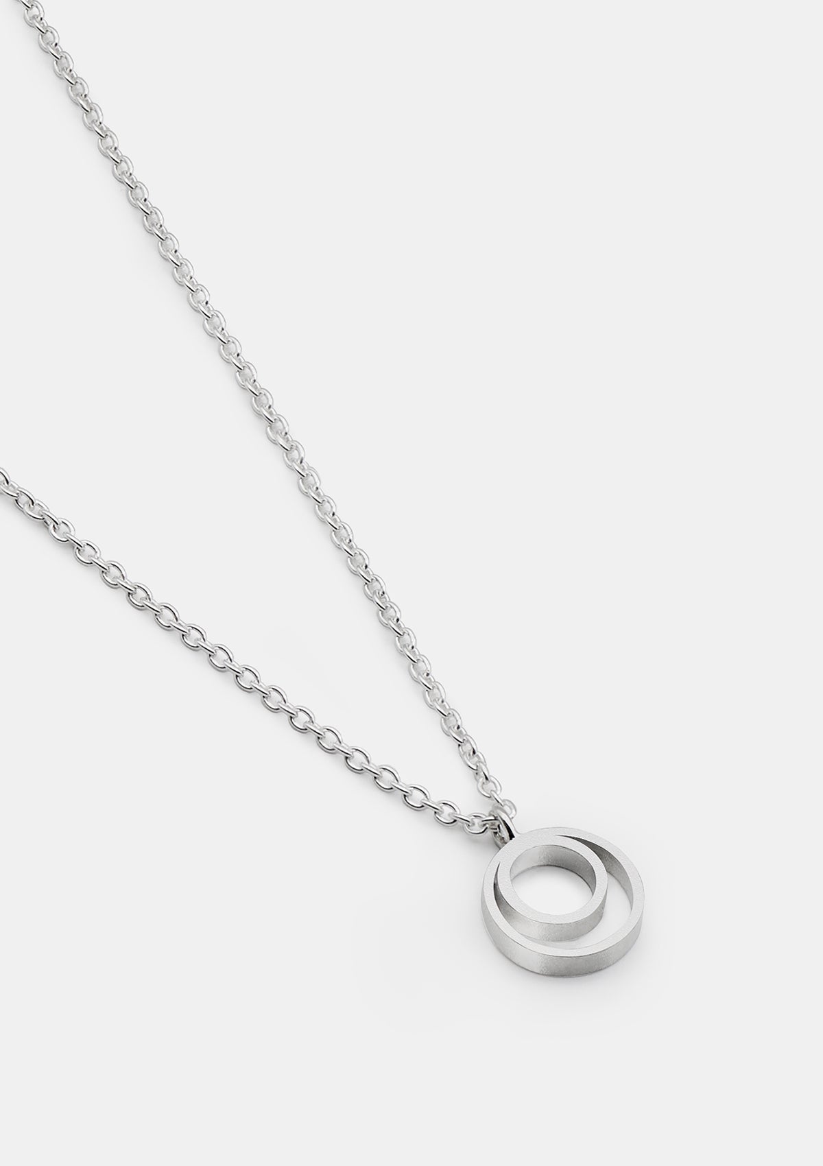 Sterling silver necklace with interlocking circles pendant, clean modern design on white background