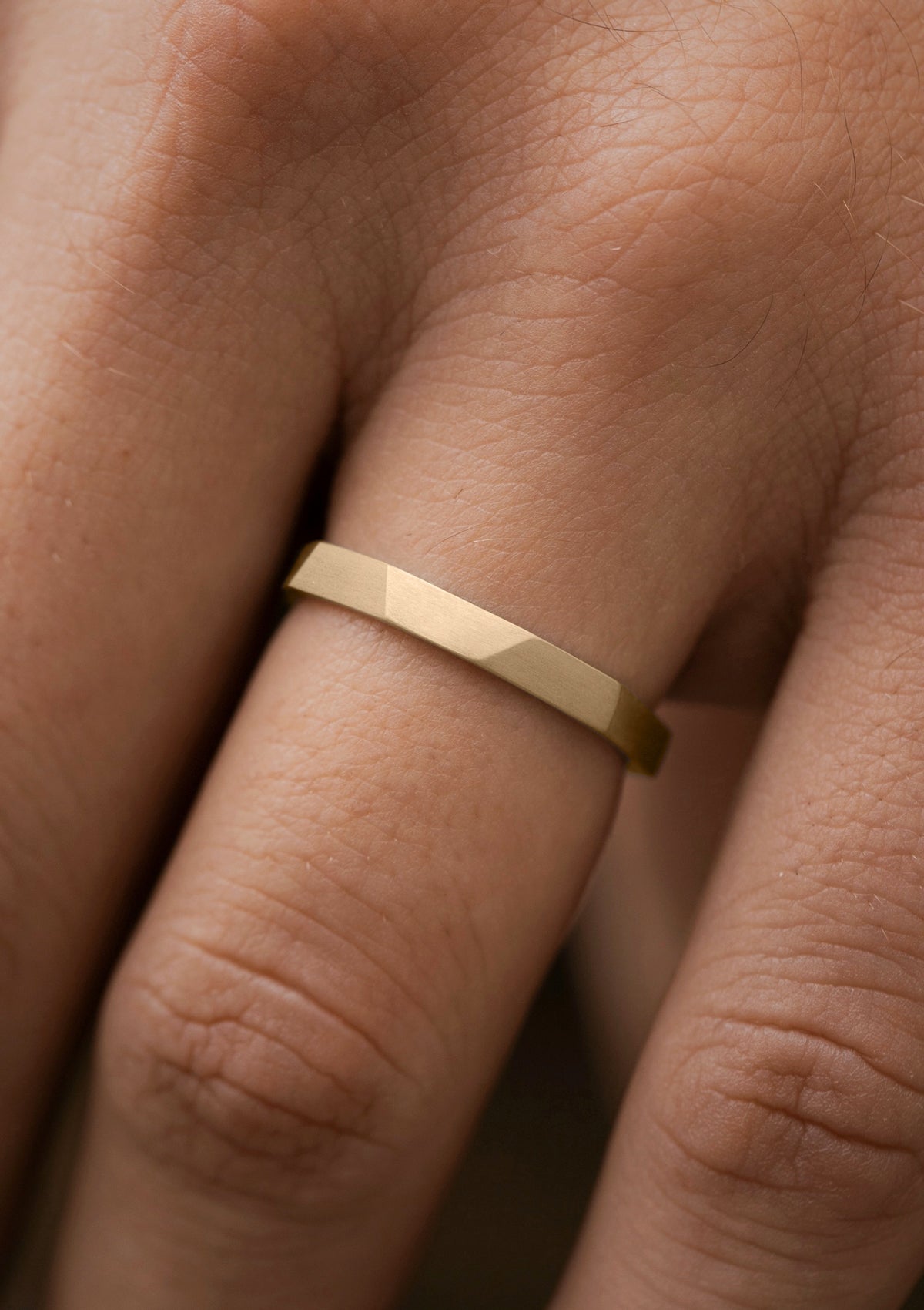 Geometric hammered mens ring with brushed texture in yellow gold, handmade detail shown in close-up