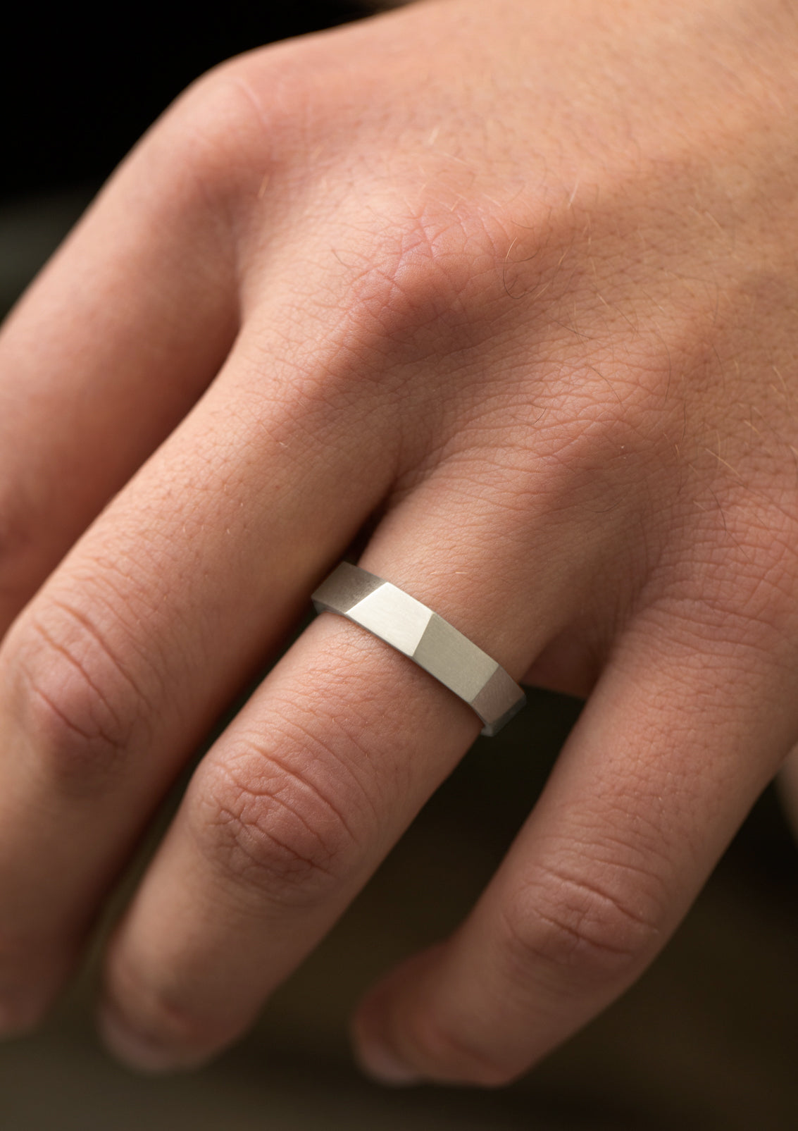 Faceted matte sterling silver ring on male hand – minimalist geometric men’s jewelry