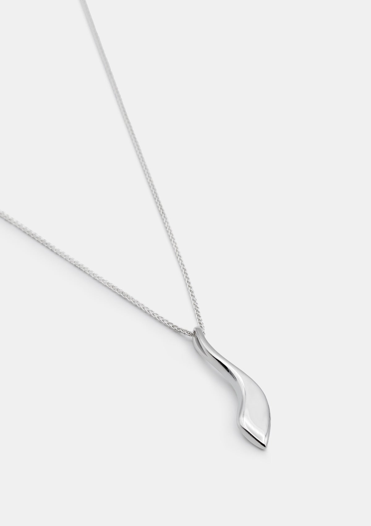 Sterling silver necklace with curved drop charm, designer piece photographed flat