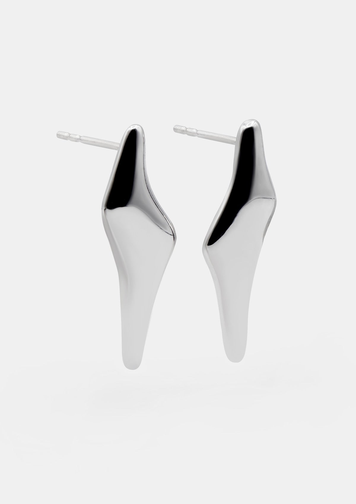 Sterling silver statement earrings with bold flat shape, medium sculptural design photographed flat