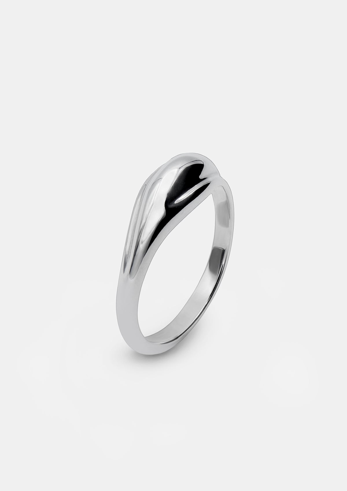 Polished sterling silver ring with a domed, minimalist shape and asymmetrical grooves, displayed on a white background