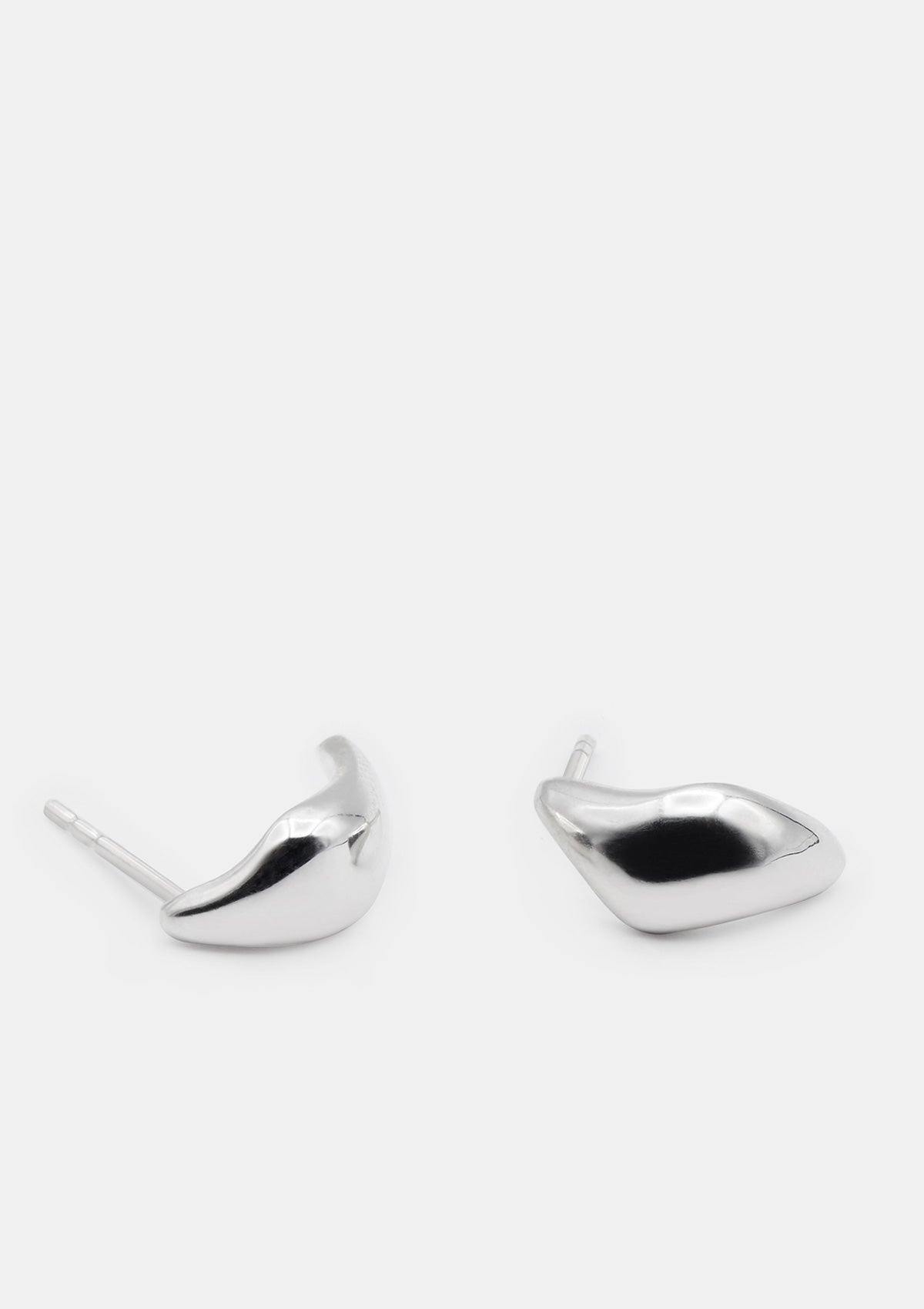 Small sterling silver huggie earrings with sculptural wave shape, hypoallergenic everyday studs