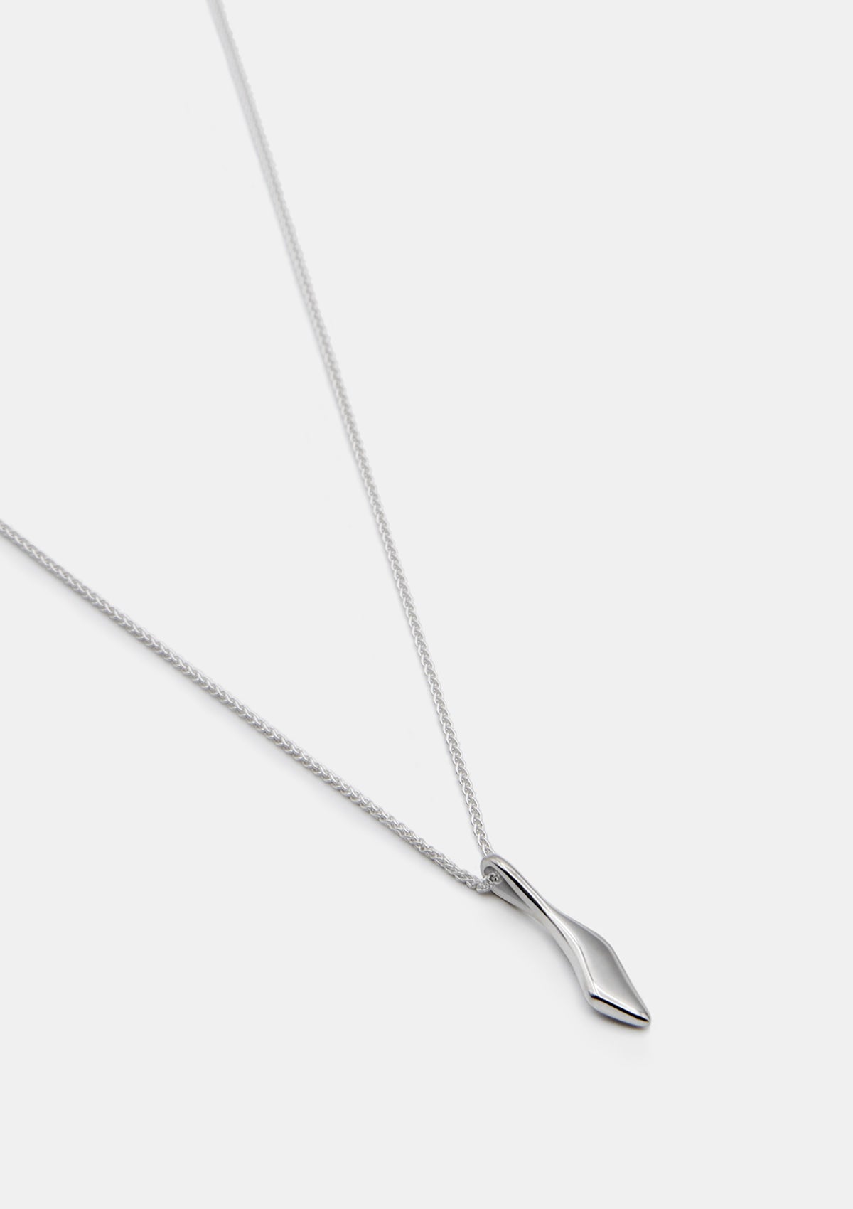 Handcrafted silver necklace with tiny sculptural pendant, designer drop jewelry photographed flat