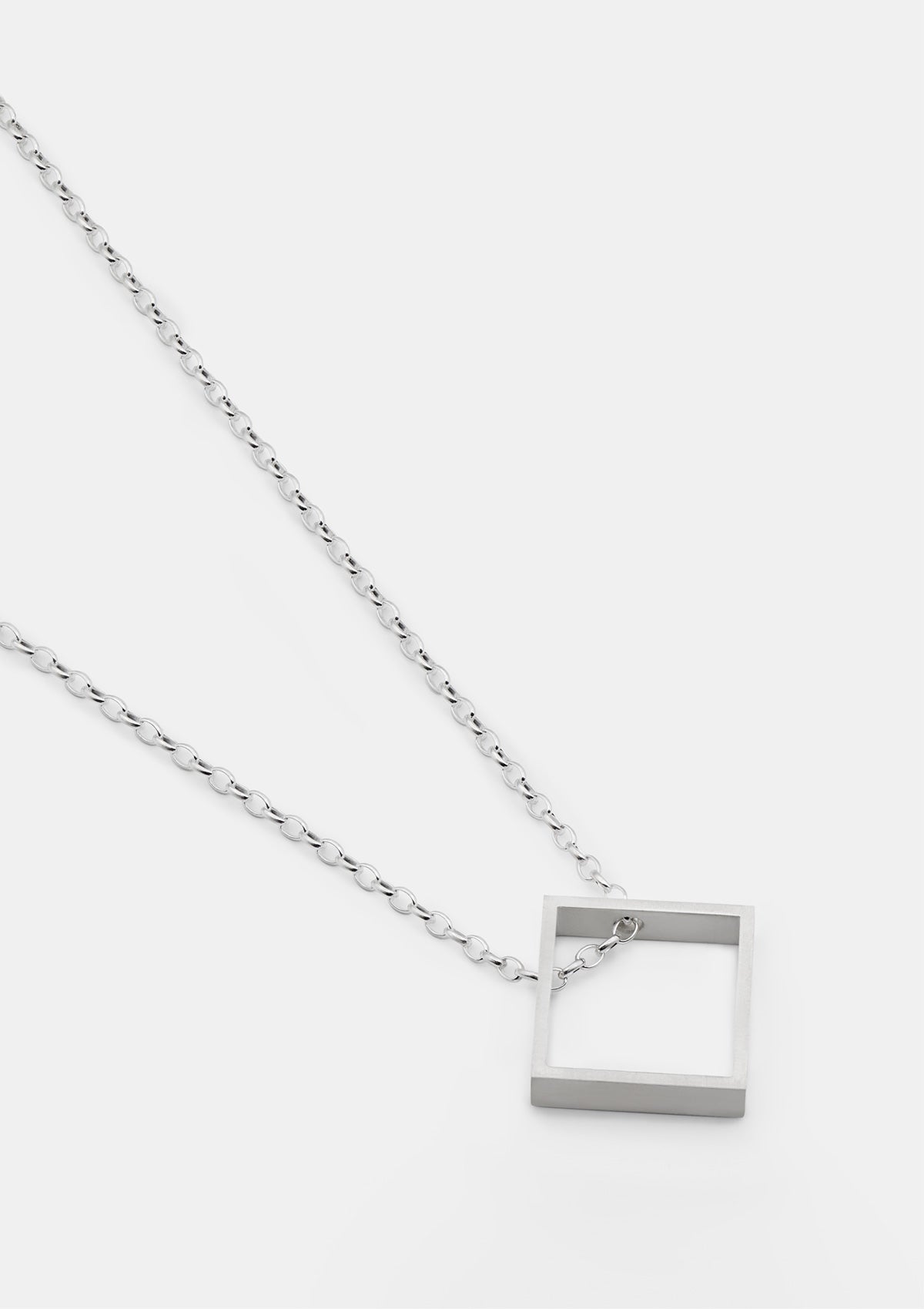 Minimalist rhombus pendant necklace in 925 sterling silver, matte finish, laid on light gray background