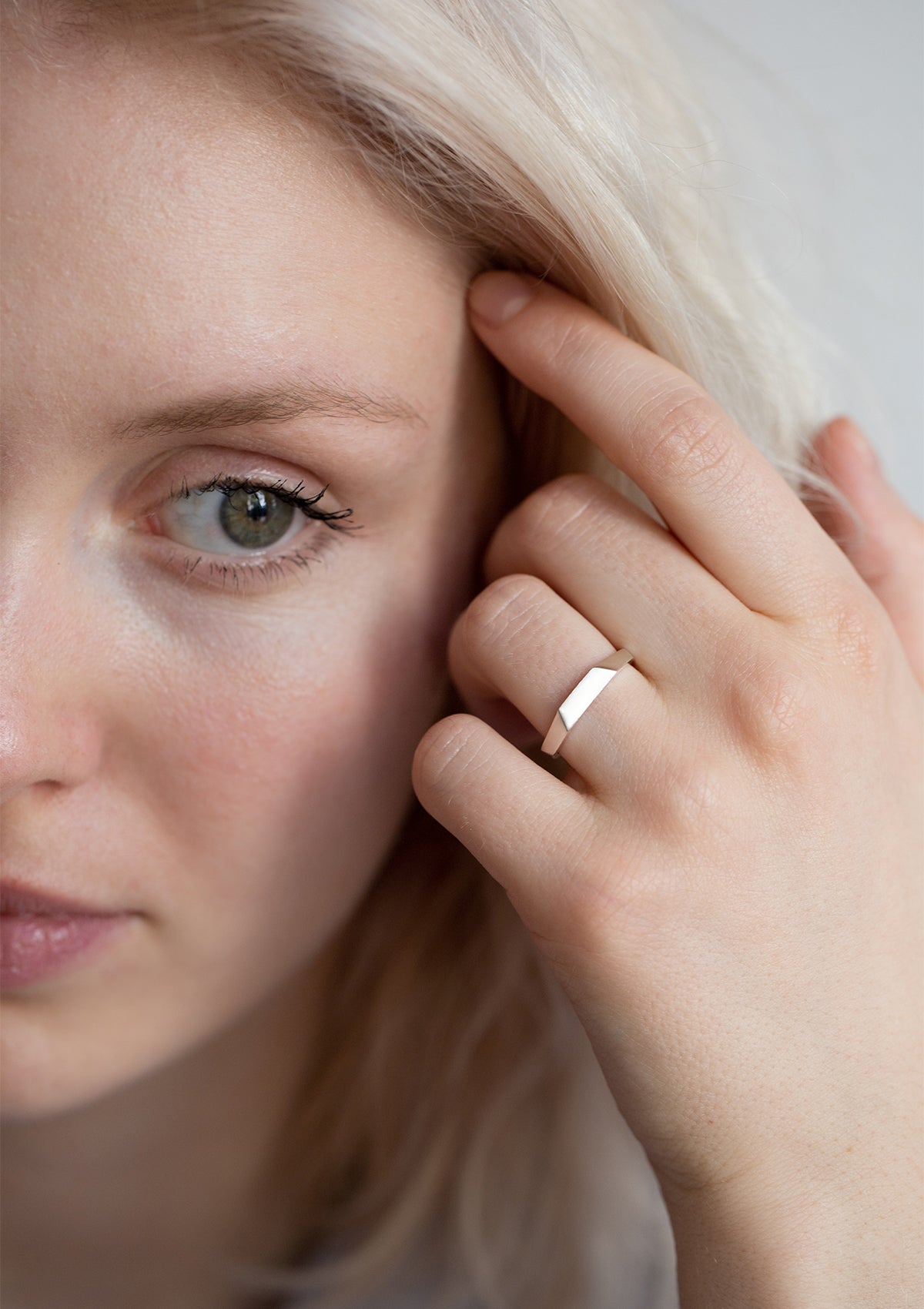 925 faceted ring with sharp shimmer, styled on hand in bright light, minimalist yet expressive design