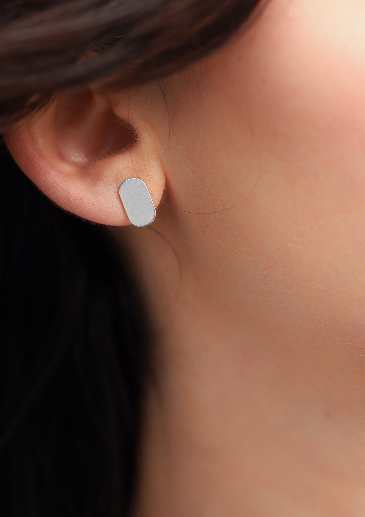 Side view of geometric silver oval earrings, flat matte finish, modern 925 sterling silver design