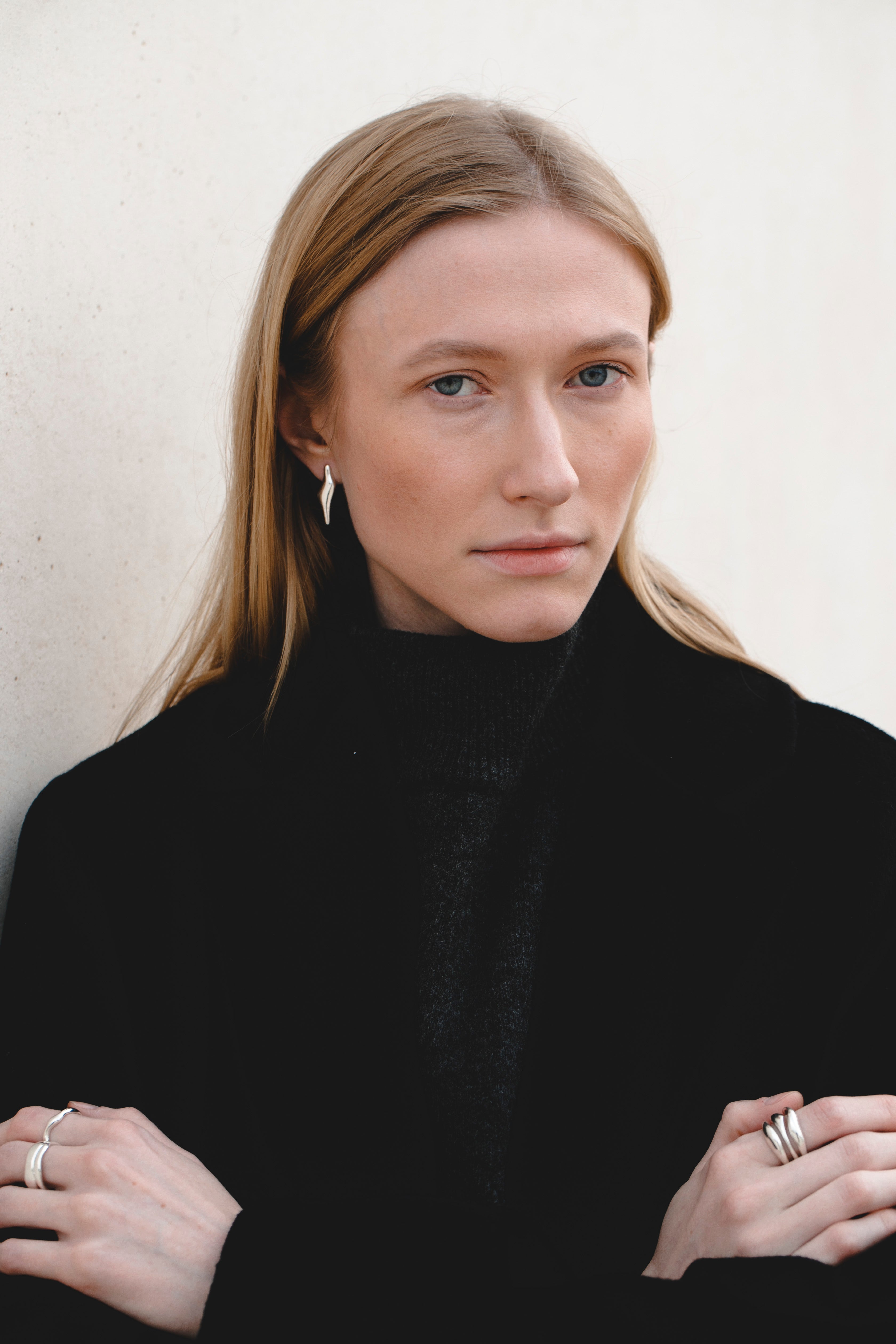 Minimalist silver ring with organic curves styled with dark outfit