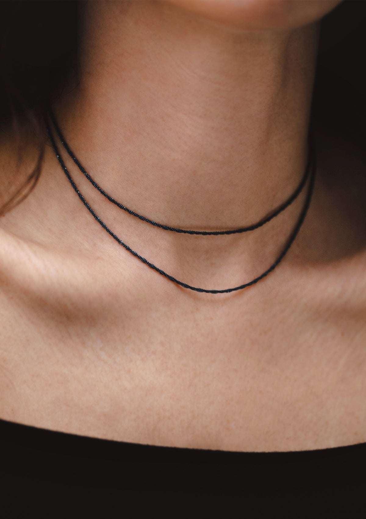 Double-chain black sterling silver choker on model, showing full layering effect