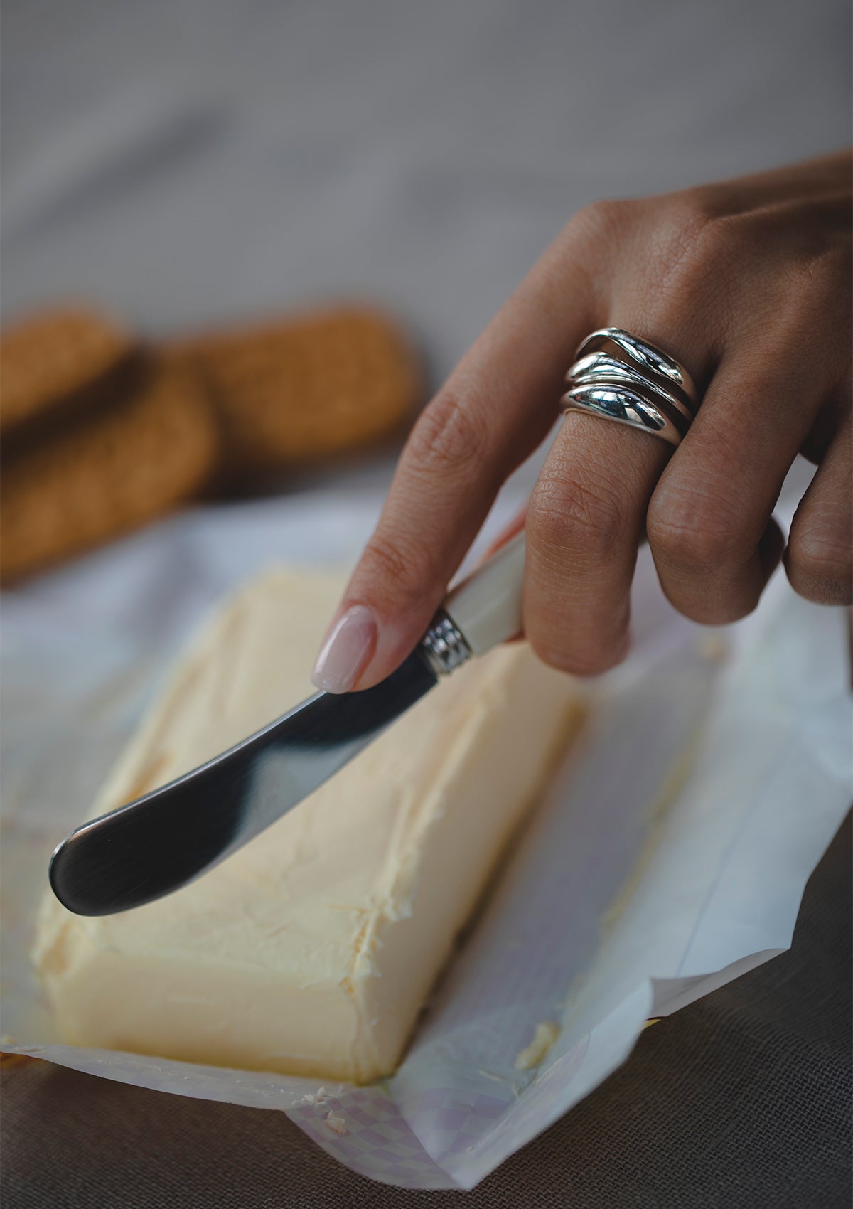 Handmade silver ring with wave-inspired form styled on hand