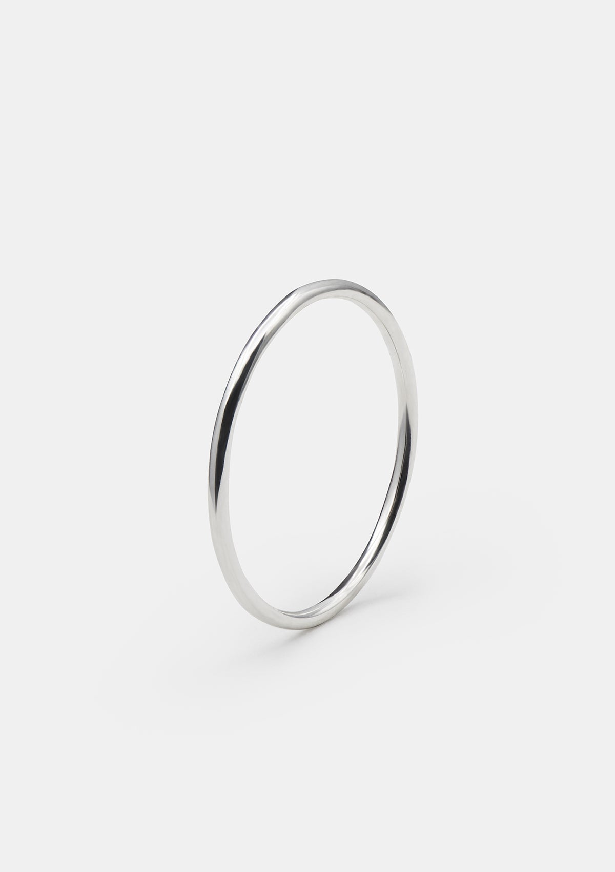 1 mm shiny sterling silver ring shown from angle to highlight thin profile